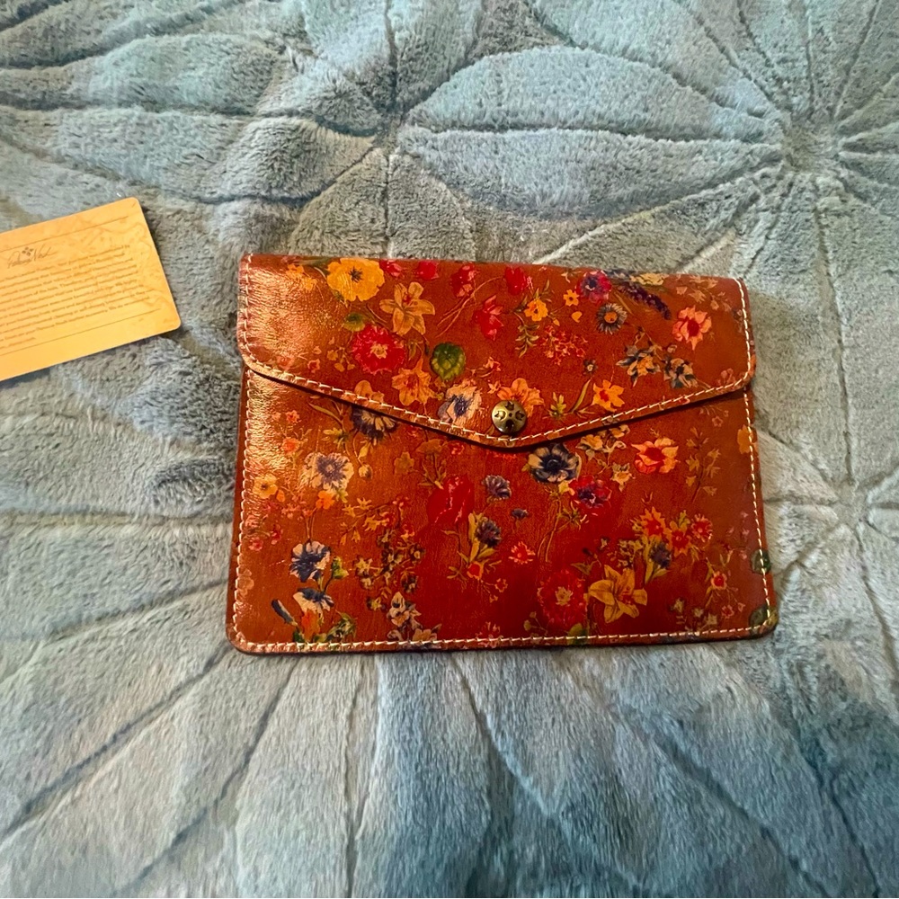 Patricia Nash leather clutch. Small floral pattern. 9” x 6 1/2”